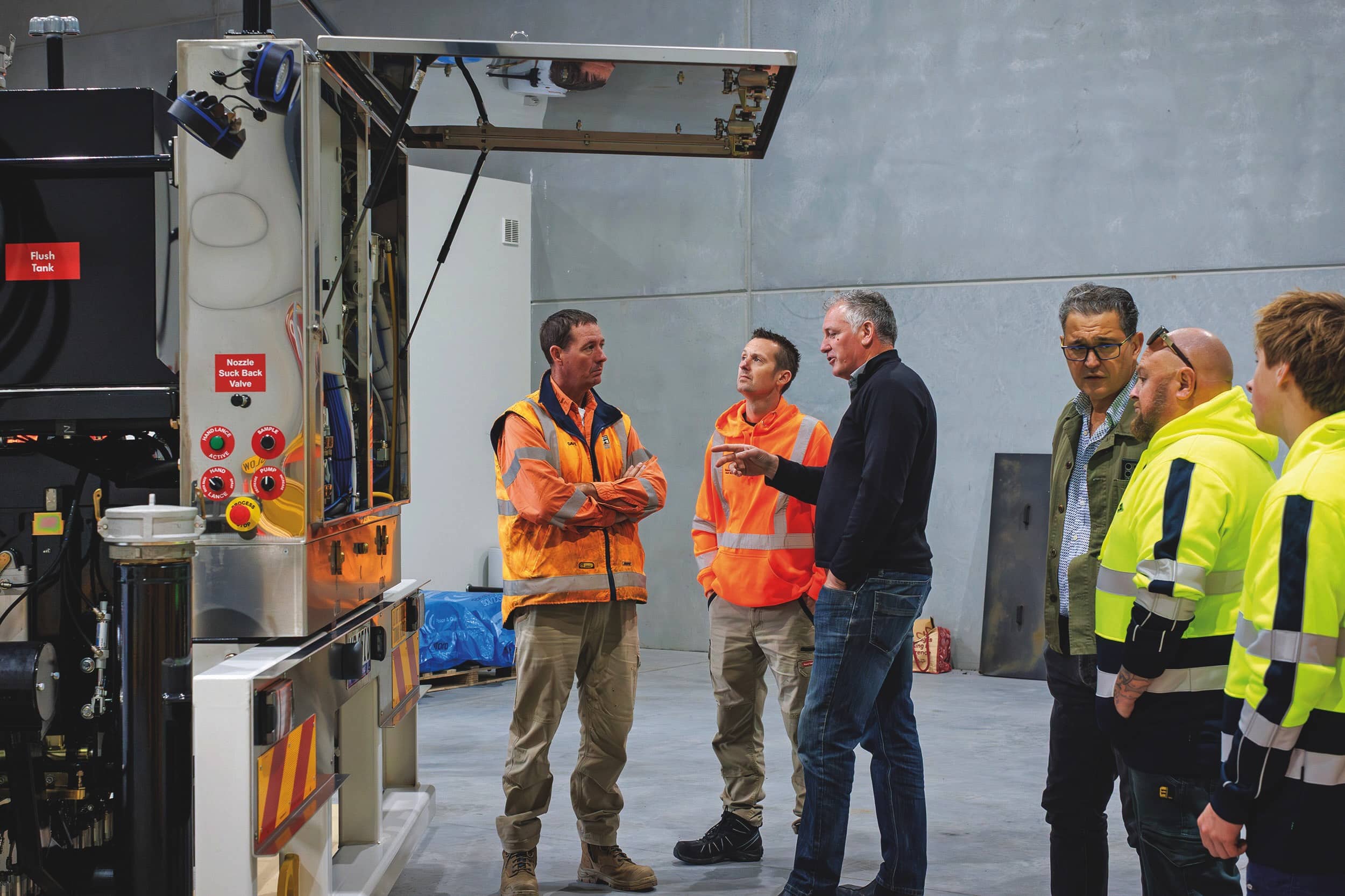 Mark Wansbrough, Managing Director – SRE (third from left) instructs interested parties on the features and capabilities of the unit at the sprayer launch event. 