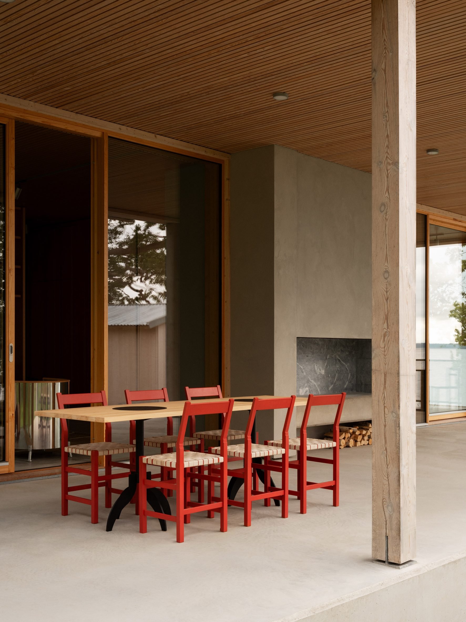 Sheltered seating area at timber summer house by Bross and Nick Flygt Arkitekter