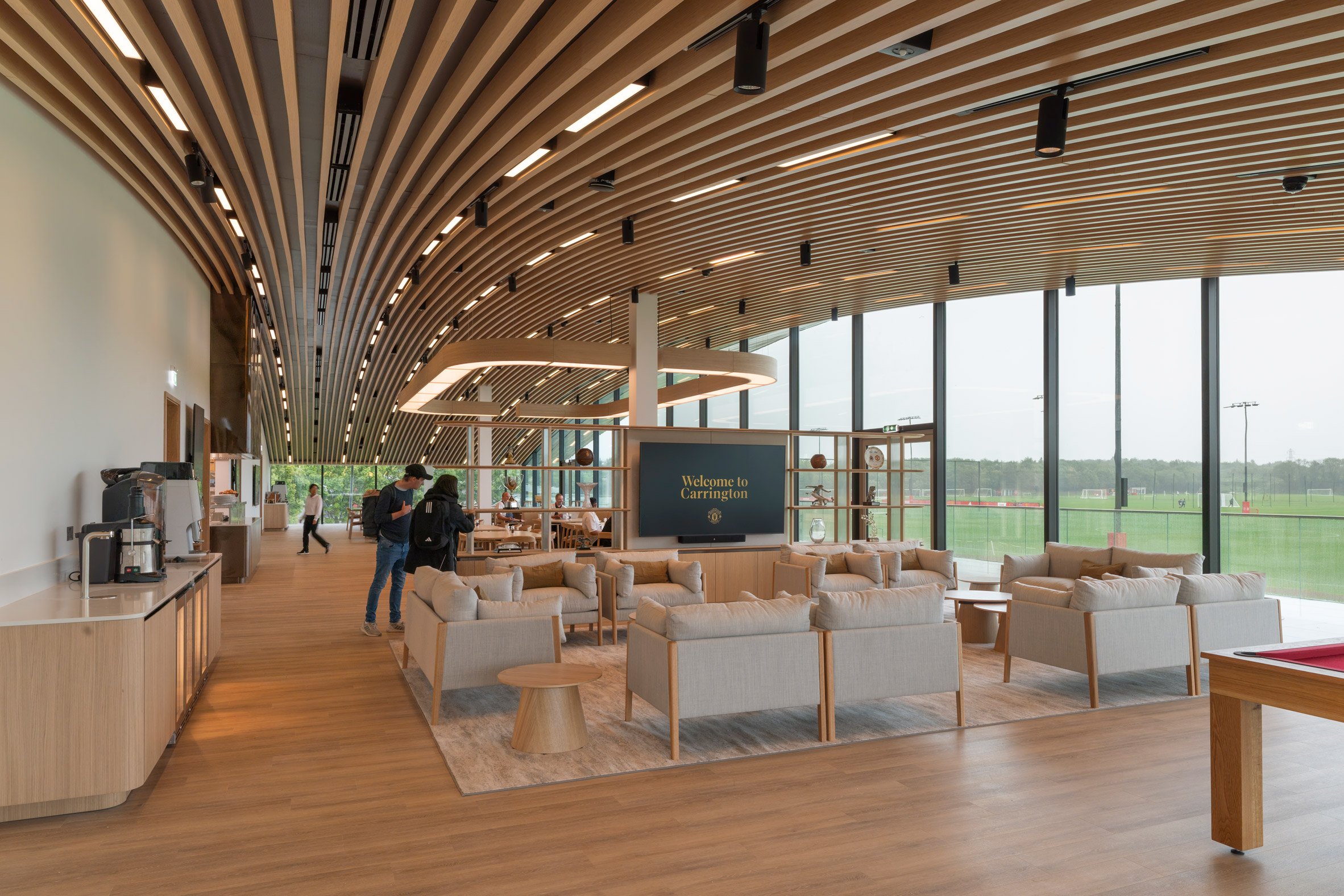 Lounge area at Carrington Training Complex by Foster + Partners