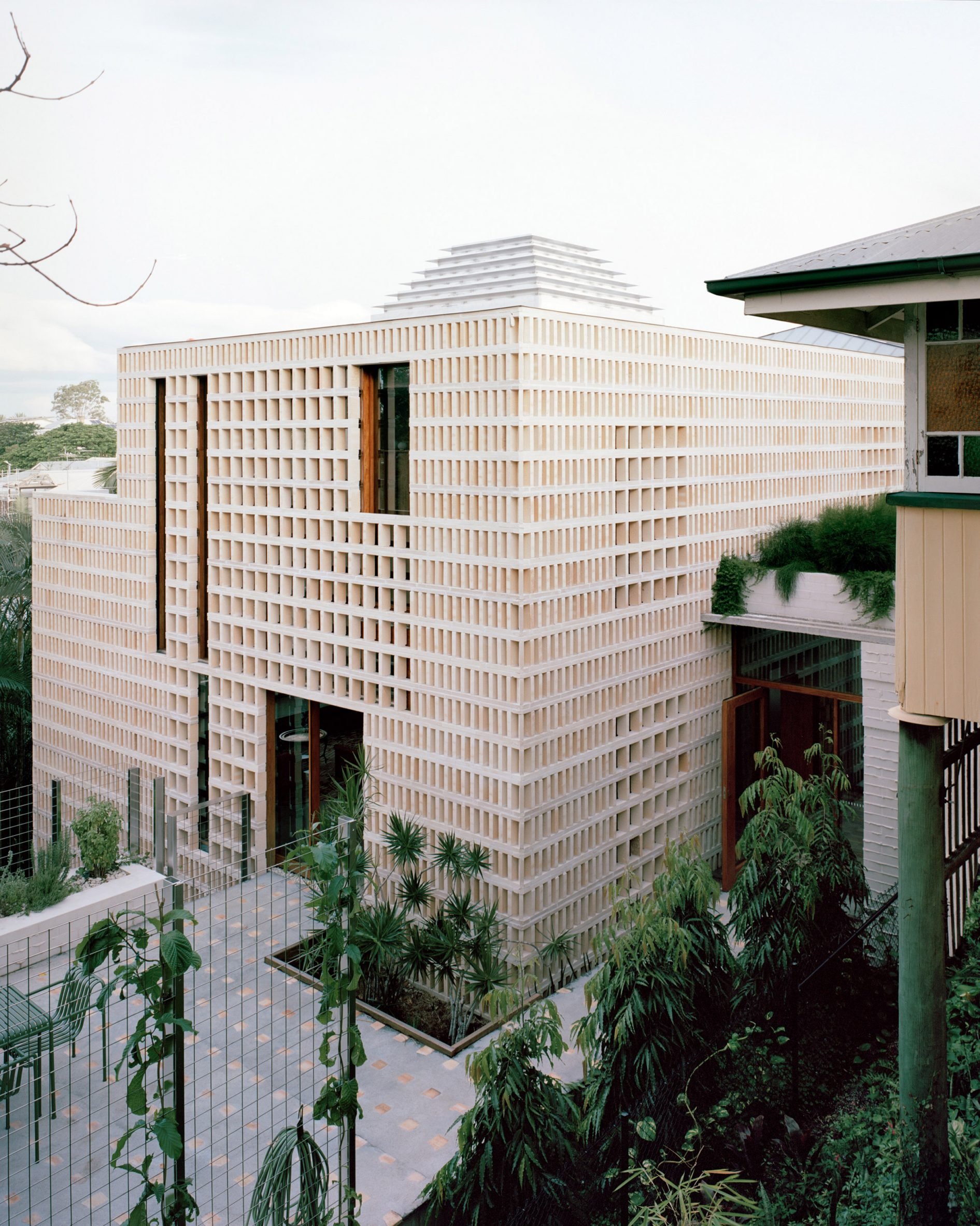 Perforated brick exterior of house by Peter Besley