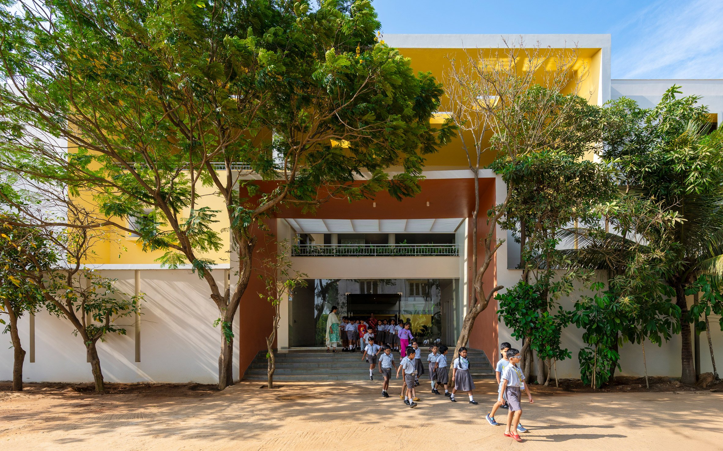 Children walking out from new school block by Spacefiction Studio