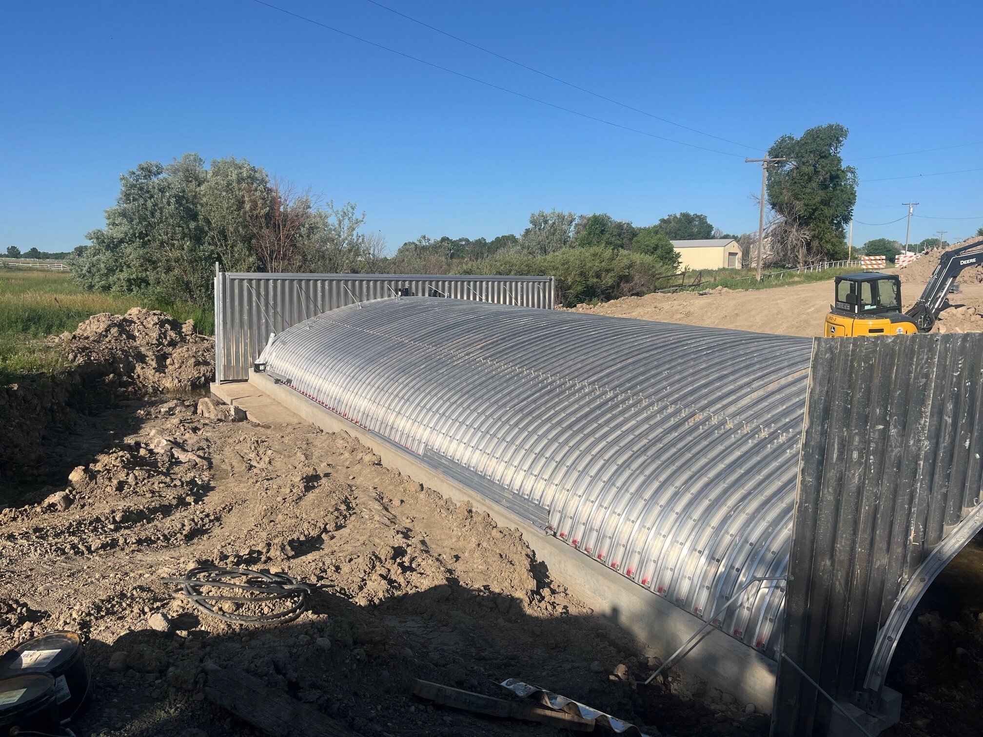 A large, corrugated steel culvert for stormwater management, installed by Lane Enterprises in Pueblo, Colorado