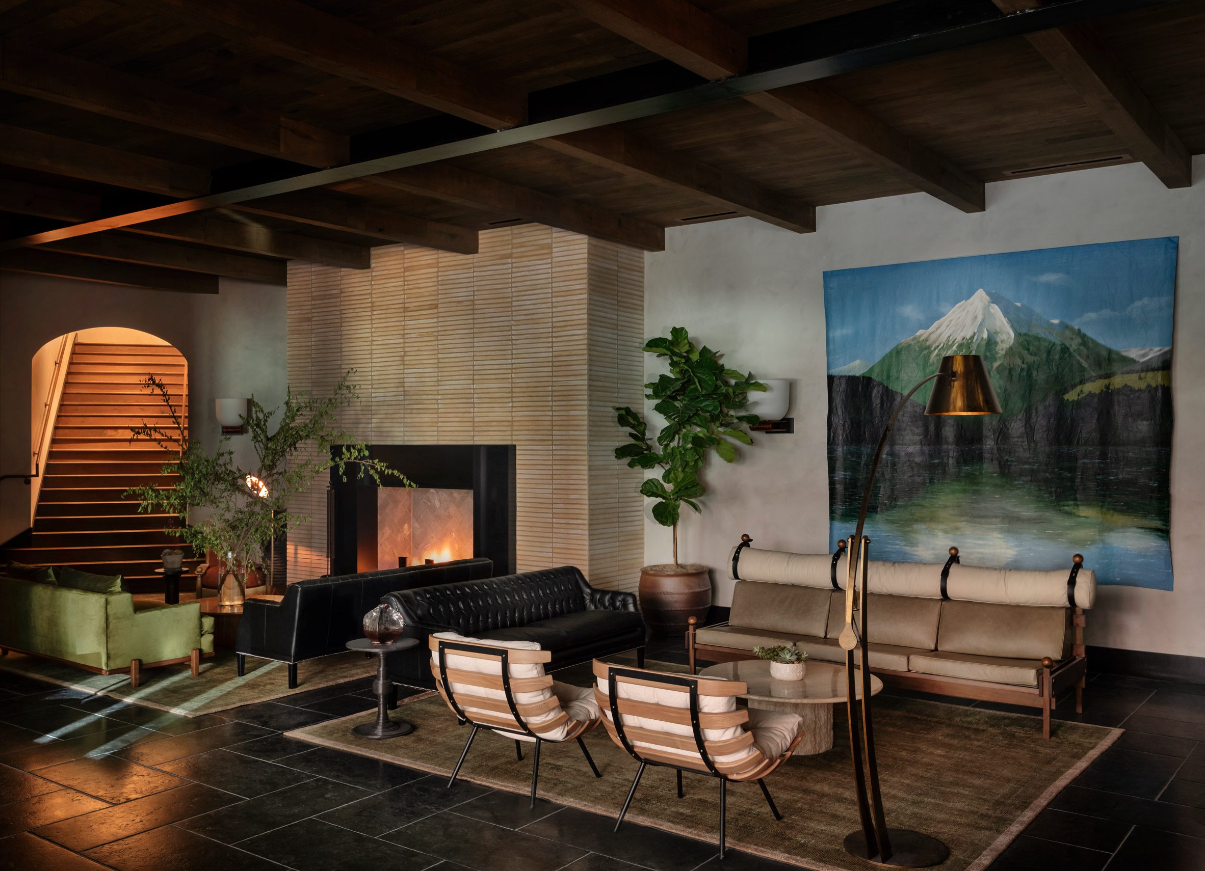 Cosy hotel lobby featuring slate floors and a large tile-clad fireplace