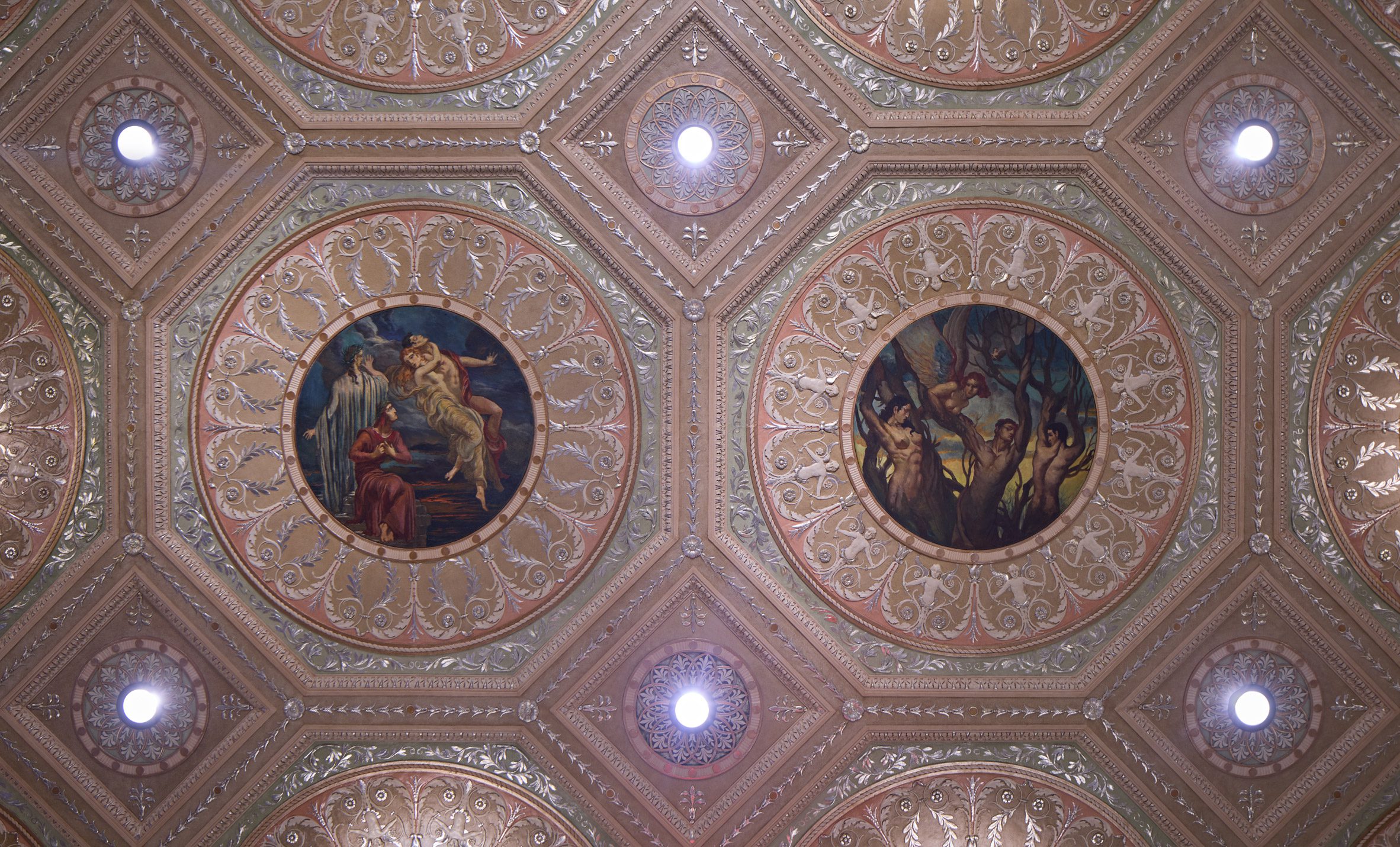 Looking up at an ornate ceiling with silver leaf details