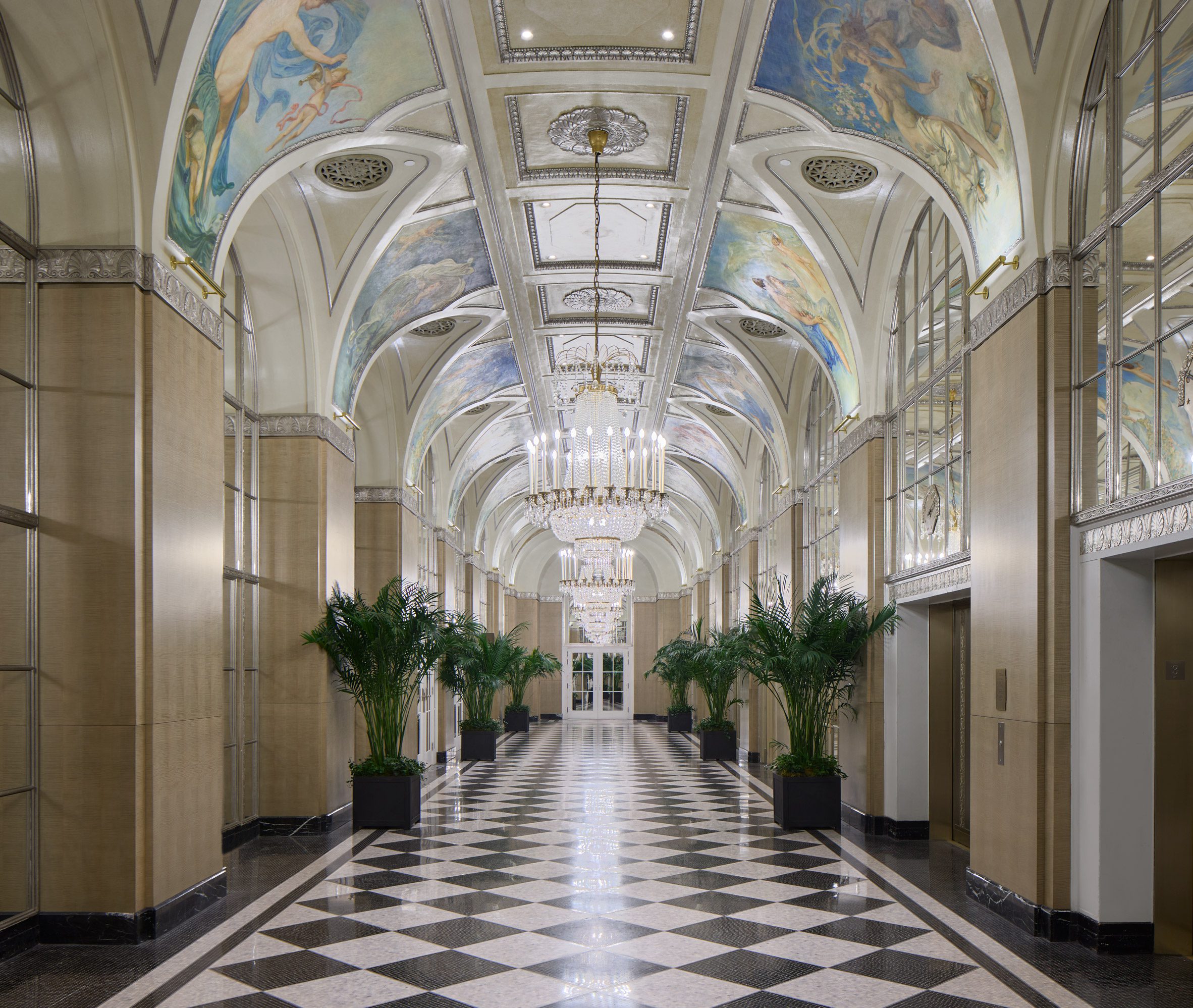 Grand corridor with mirrored panels and ceiling murals