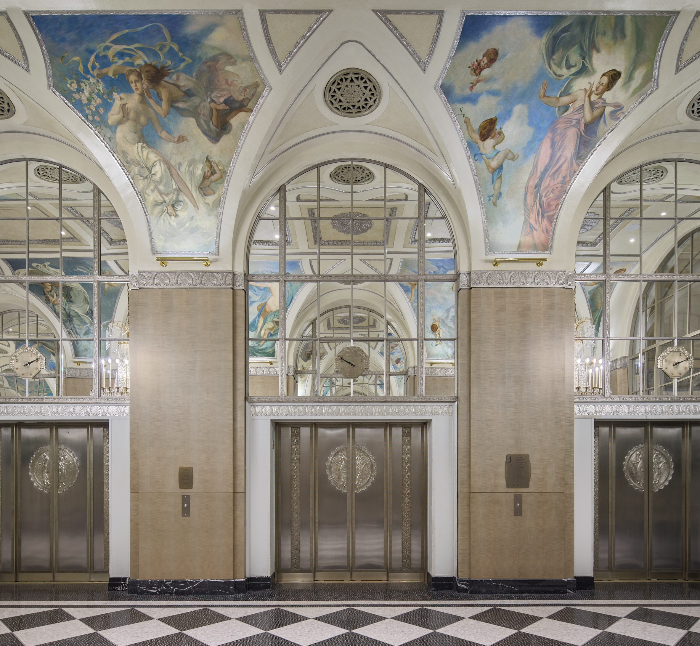 Grand corridor with elevator bank and murals on the ceilings