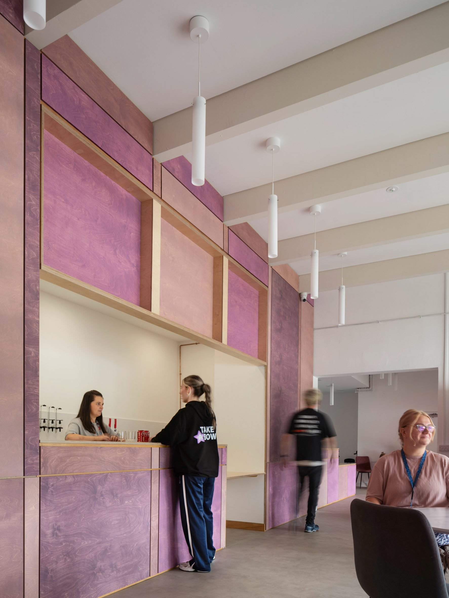 Purple plywood reception and bar inside Take A Bow centre