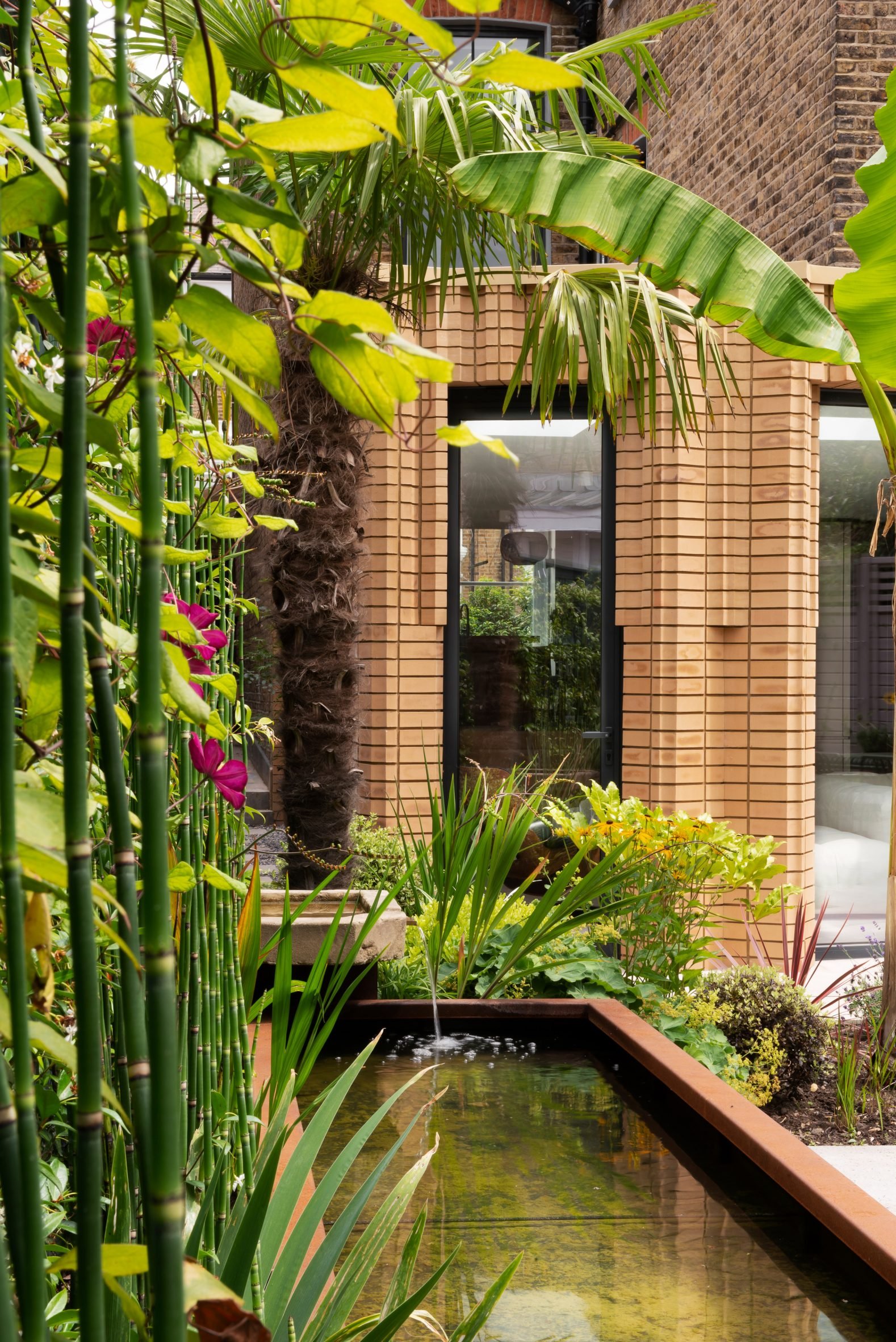 Brick extension leading onto landscaped garden