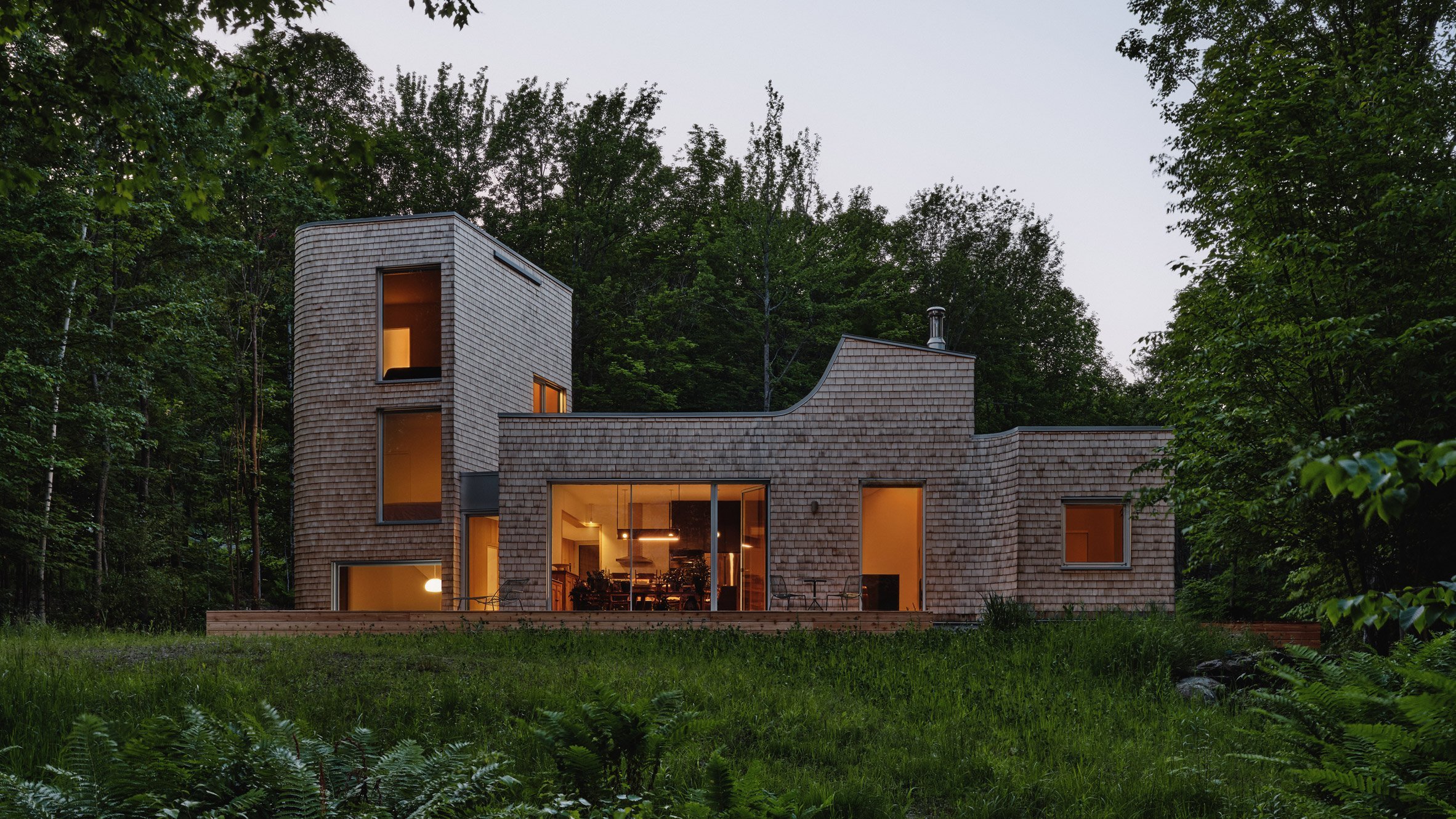 Shingle-clad house in the woods Canada